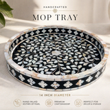 Handcrafted mop tray with intricate black and white design on a light surface.